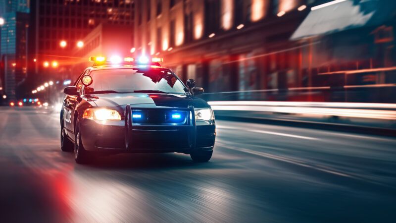 AI-generated image of a police car speeding down a city street at night. | Gearstd | Dreamstime.com