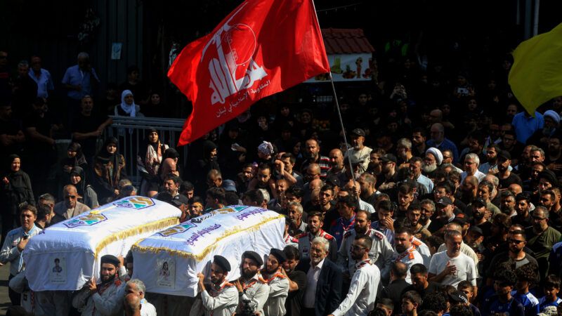 Lebanese mourners carry the coffins of two children, Hassan and Amira Muhammed Fadallah, who were killed in the Israeli drone attack on Beirut on July 30, 2023. | Marwan Naamani/dpa/picture-alliance/Newscom