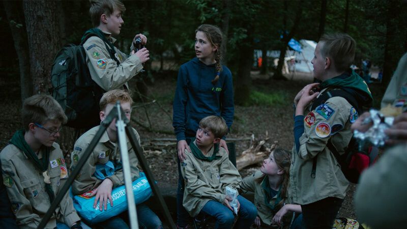 A group of children gathered in the woods | Photo: Dmitry Kostyukov