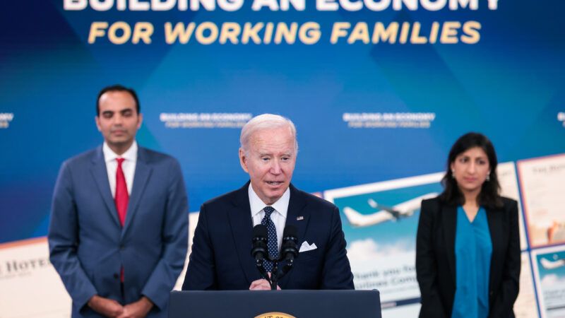 Joe Biden speaks at a podium with Lina Khan and Rohit Chopra in the background | Oliver Contreras/Sipa USA/Newscom