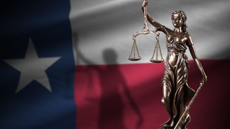 Texas flag with a statue of Lady Justice | Mehaniq/Newscom