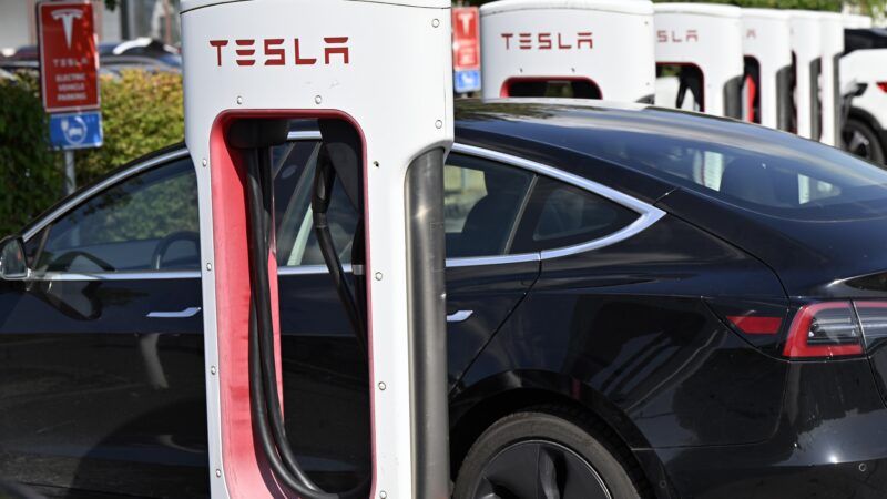 Teslas parked at a charging station | Eric Lalmand/ZUMAPRESS/Newscom