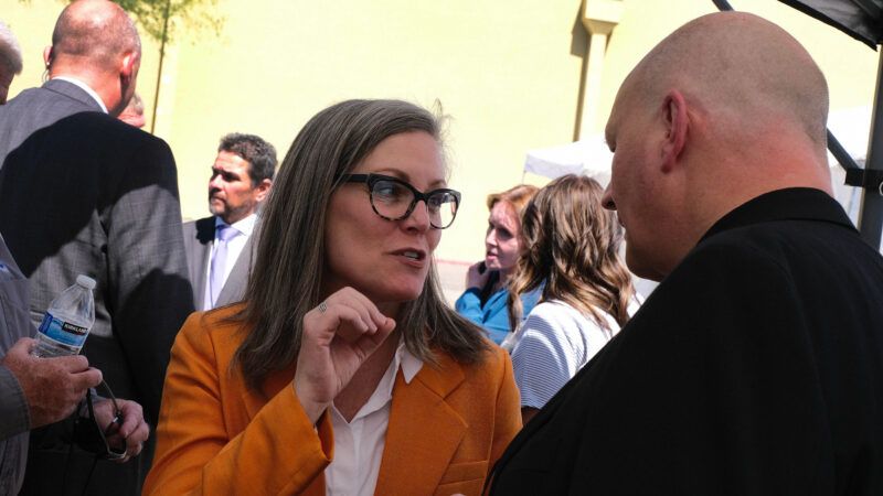 Arizona Gov. Katie Hobbs speaks to someone facing away from the camera. | Christopher Brown/ZUMAPRESS/Newscom