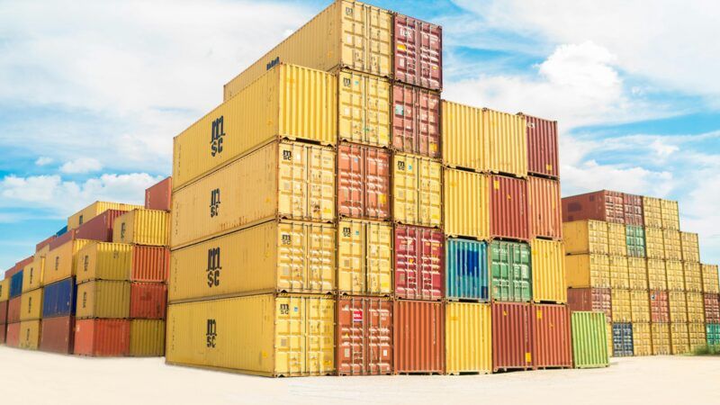 Stacks of cargo containers at a port | Photo by frank mckenna on Unsplash