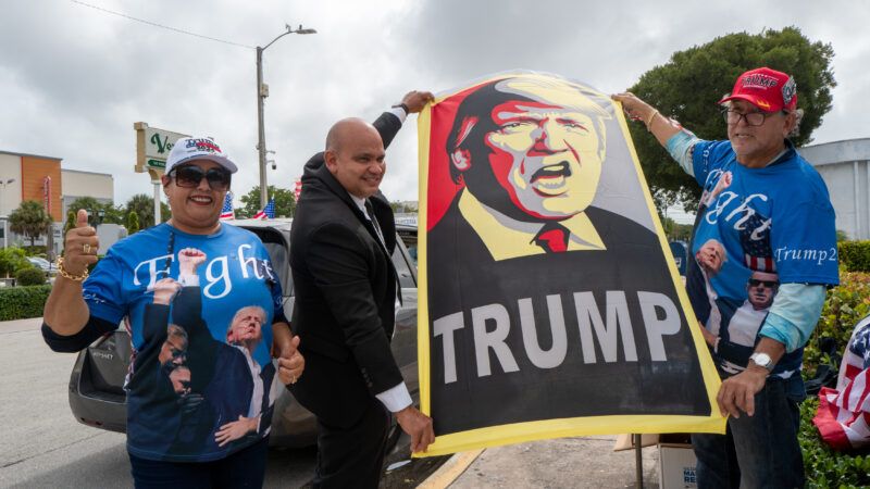 People holding up a poster of Trump | Alberto E. Tamargo/Sipa USA/Newscom