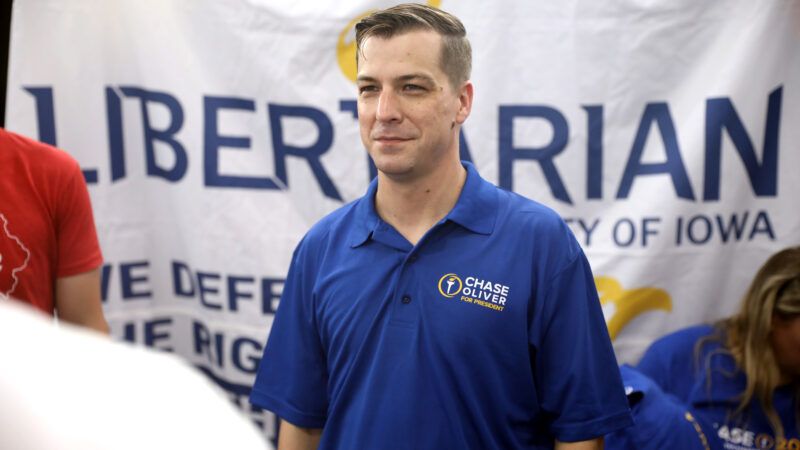 Libertarian presidential candidate Chase Oliver speaks in Surprise, Arizona, in front of a banner that reads "LIBERTARIAN" | Gage Skidmore/ZUMAPRESS/Newscom