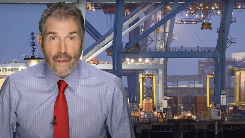 John Stossel is seen in front of a port | Stossel TV