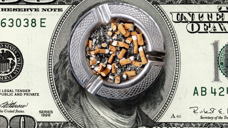 A U.S. 0 bill with an ashtray on top full of discarded cigarette butts. | jokerpro/Newscom