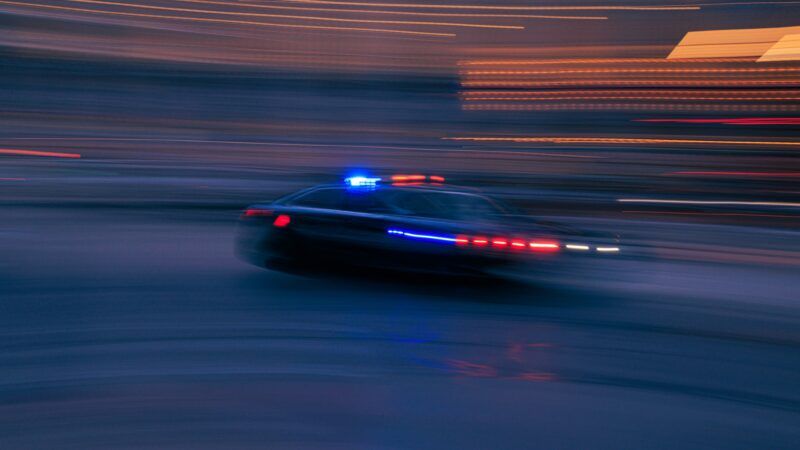 A police car during a chase | Photo by <a href="https://unsplash.com/@abject?utm_content=creditCopyText&utm_medium=referral&utm_source=unsplash">benjamin lehman</a> on <a href="https://unsplash.com/photos/a-police-car-driving-down-a-street-at-night-eqkdWtwct64?utm_content=creditCopyText&utm_medium=referral&utm_source=unsplash">Unsplash</a>       