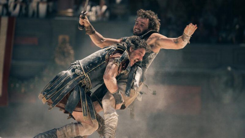 Promotional image from Gladiator II of one man tackling another | <em>Gladiator II</em>/Paramount Pictures