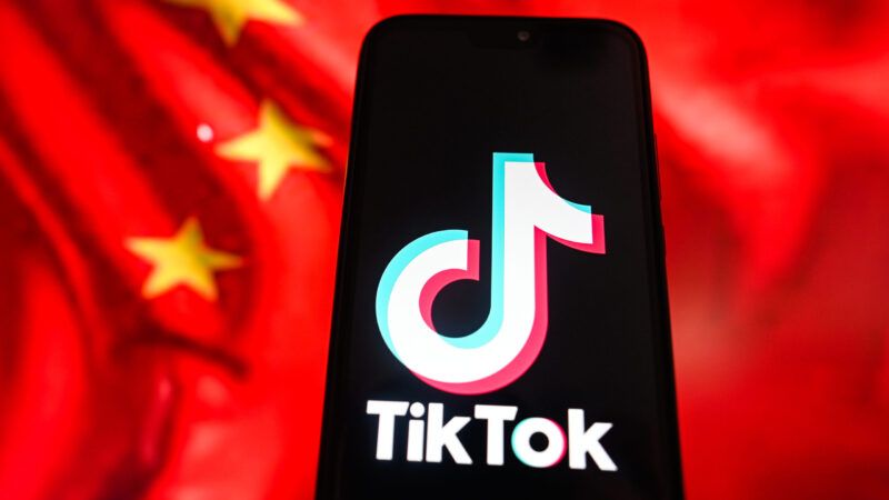 A phone screen with the TikTok logo on it, in front of a partial image of the Chinese flag, including three yellow stars. | Omar Marques/ZUMAPRESS/Newscom