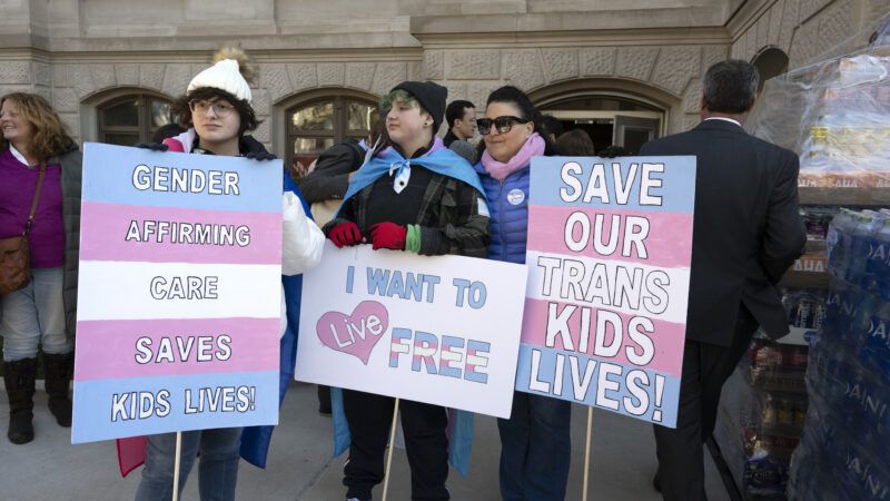 protesters holding pro transgender signs | Robin Rayne/ZUMAPRESS/Newscom