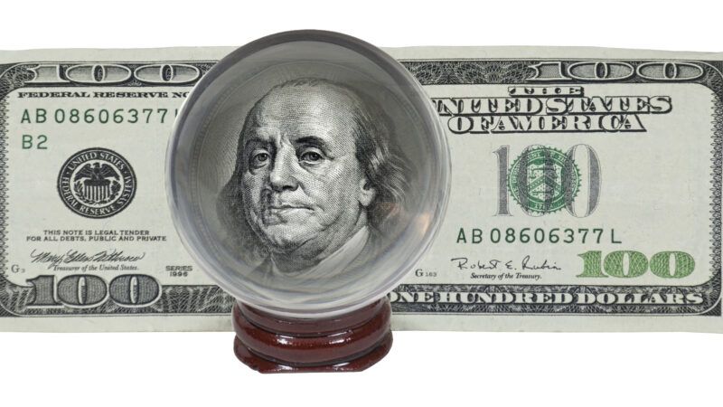 A U.S. 0 bill, with the picture of Benjamin Franklin magnified by a crystall ball. | Penywise | Dreamstime.com