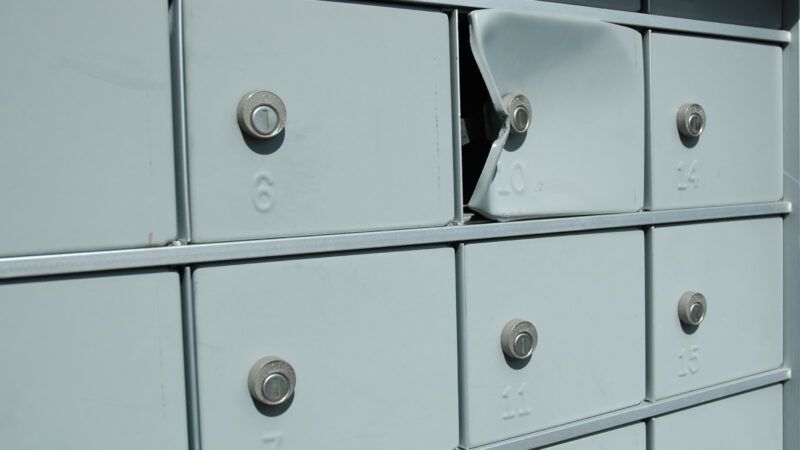 A row of post office boxes, where one has been forced open. | Karin Hildebrand Lau | Dreamstime.com