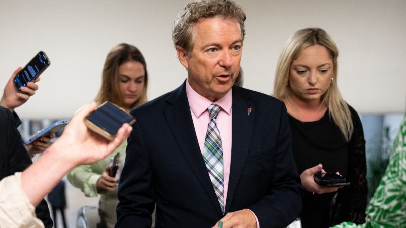 U.S. Senator Rand Paul stands in a small crowd including journalists recording on their cell phones |  Bill Clark/Newscom