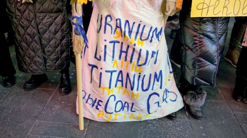 A woman wearing dress with Ukraine minerals as hundreds converged on Times Square to support Ukraine | Milo Hess/ZUMAPRESS/Newscom