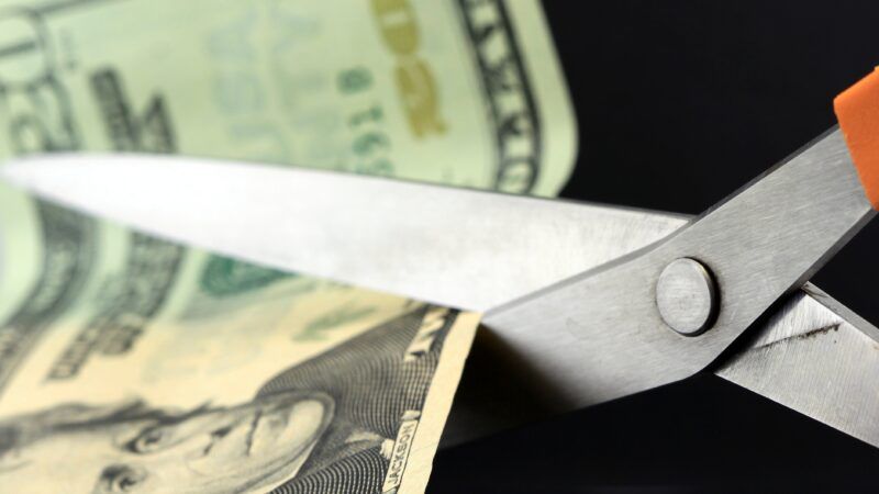 A  bill is cut with scissors | ID <a href="https://www.dreamstime.com/royalty-free-stock-photography-budget-cuts-inflation-image23617897">23617897</a> ©  <a href="https://www.dreamstime.com/larryhw_info">Larryhw</a> | <a href="https://www.dreamstime.com/">Dreamstime.com</a>