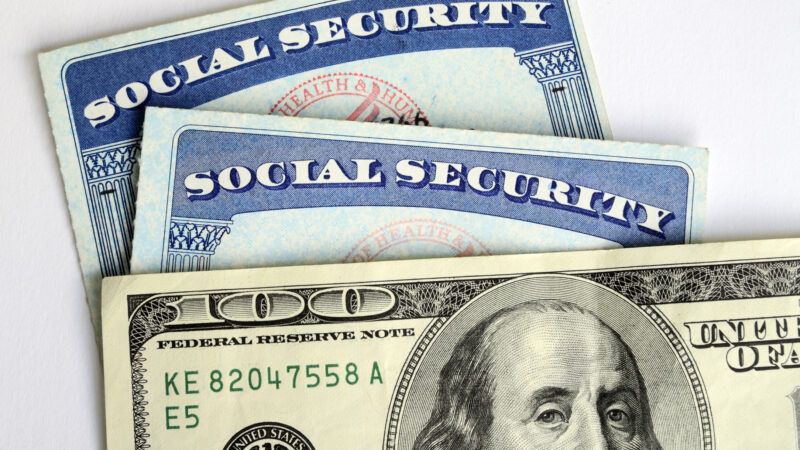 A U.S. 0 bill in a stack with two Social Security cards. | Yukchong Kwan | Dreamstime.com