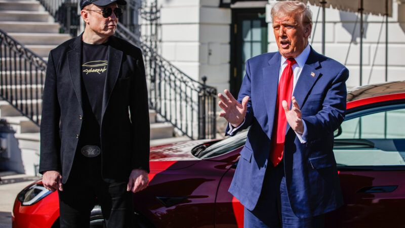 President Donald Trump speaks to reporters in front of the White House. He stands in front of a red Tesla Model S, alongside Tesla Motors CEO Elon Musk. | Samuel Corum - Pool via CNP/CNP / Polaris/Newscom