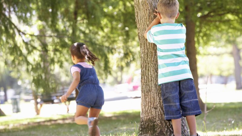 Two kids play hide and seek: A little boy covers his eyes while a little girl runs off to hide. Two kids play hide and seek: A little boy covers his eyes while a little girl runs off to hide. | Monkey Business Images | Dreamstime.com