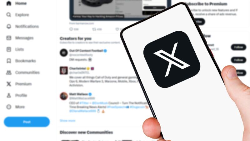A hand holds a cell phone with the logo for X (formerly Twitter) on the screen, while in the background, a computer displays the X homepage. | Boarding1now | Dreamstime.com