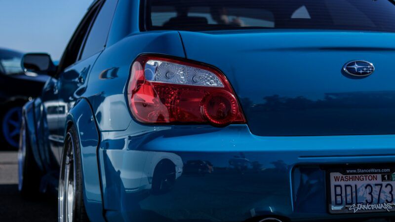 A blue Subaru vehicle as seen from behind | Photo by sgcdesignco on Unsplash