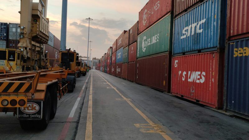 Shipping containers stacked at a port | Photo by Sompop S on Unsplash
