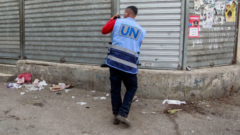 Someone with a United Nations vest is seen taking a photo of the closed Palestinian shops during a general strike in the West Bank. Apr 7, 2025. | Nasser Ishtayeh/ZUMAPRESS/Newscom