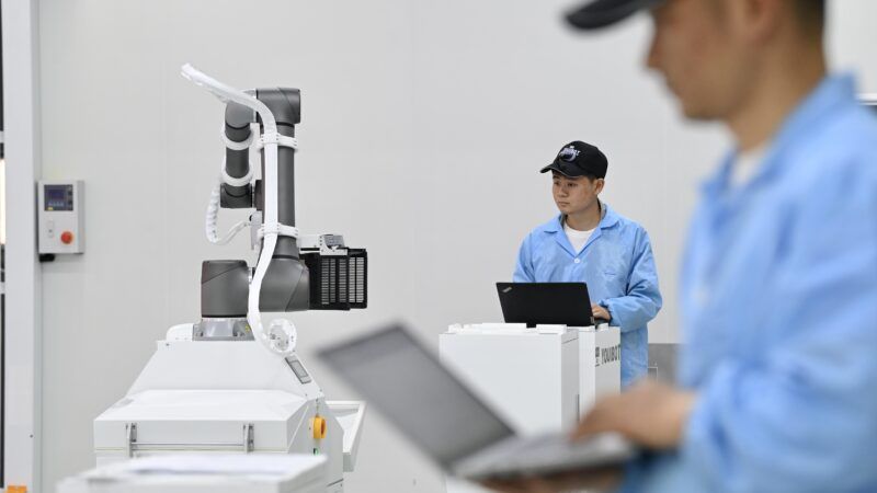 Technicians work at an industrial robot manufacturing factory in Hefei City in China. | Imagine China/Newscom