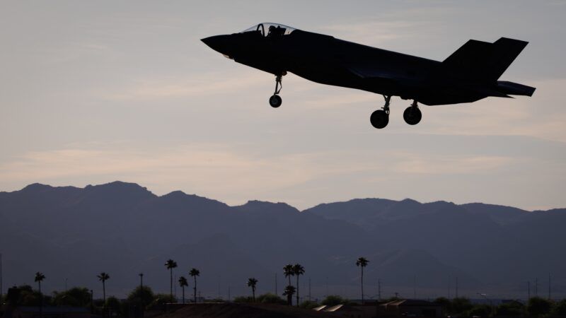 An F-35 fighter jet landing at Luke Air Force Base in Glendale, Arizona, at dusk. Mountains are visible in the background. | BENOIT DOPPAGNE/Belga/Sipa USA/Newscom