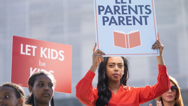 A protester holds a sign that says "Let parents parents," during oral arguments for the Supreme Court case "Mahmoud v. Taylor." | Tom Williams/CQ Roll Call/Newscom