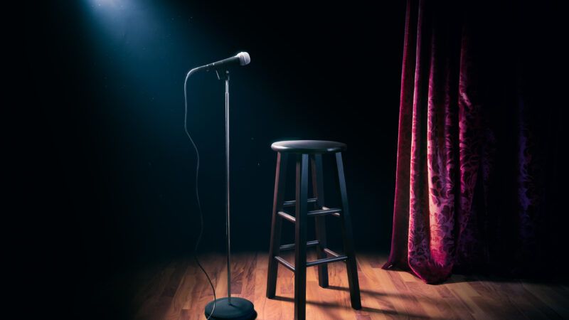 A stage with a stool and a microphone on a mic stand, under a spotlight, as if at a comedy club. | Fernando Gregory | Dreamstime.com