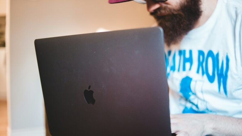 Man sitting with a laptop |  Photo by Erik Mclean on Unsplash