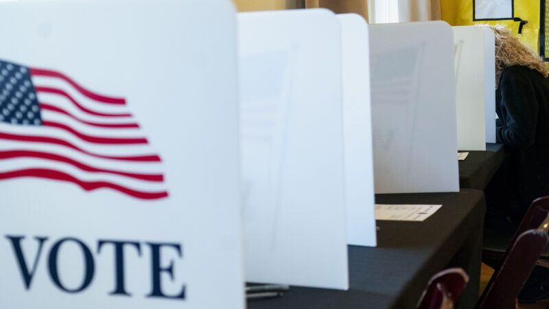 A polling place in Virginia, with dividers set up that say "VOTE" with an American flag. | BONNIE CASH/UPI/Newscom
