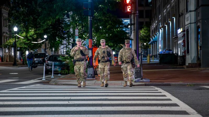 Three Tennessee National Guardsmen walk through a crosswalk in Washington, D.C. | Polaris/Newscom