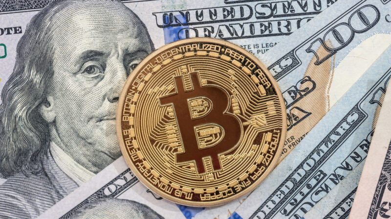 A bitcoin against U.S. currency | ID 104142472 | Dollar ©  Roman Romaniuk | Dreamstime.com