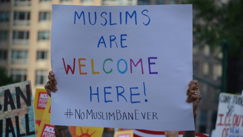 Protester holding sign supporting Muslims | Temporary Protected Status