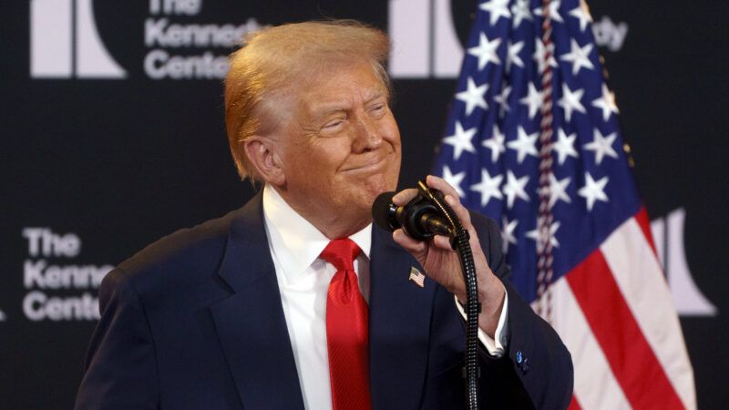 Donald Trump speaks into a microphone with an American flag and The Kennedy Center logo behind him Donald Trump speaks into a microphone with an American flag and The Kennedy Center logo behind him | Will Oliver - Pool via CNP