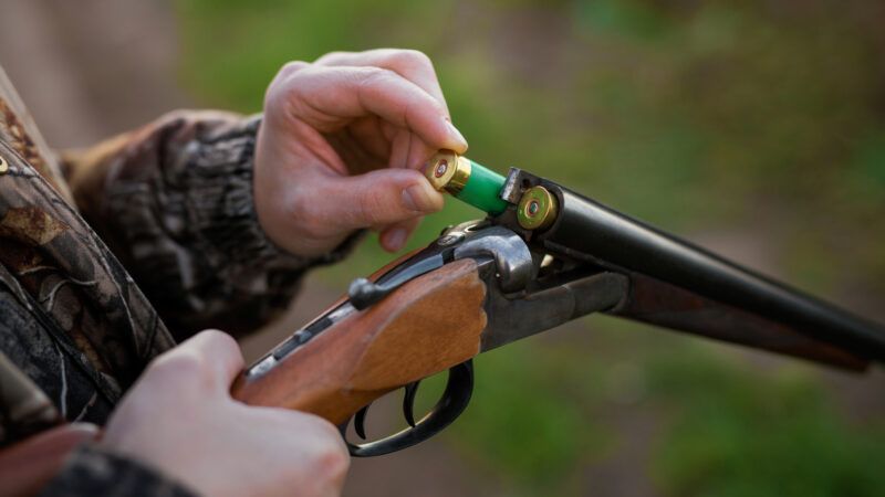 Close-up of a hunter's hands loading shells into a double-barreled shotgun. | Kaspars Grinvalds | Dreamstime.com
