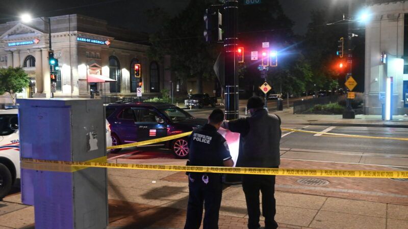 Two investigators with the Washington, D.C., Metropolitan Police Department stand behind yellow tape at the scene of a stabbing. | Kyle Mazza, Kyle Mazza/ZUMAPRESS/Newscom