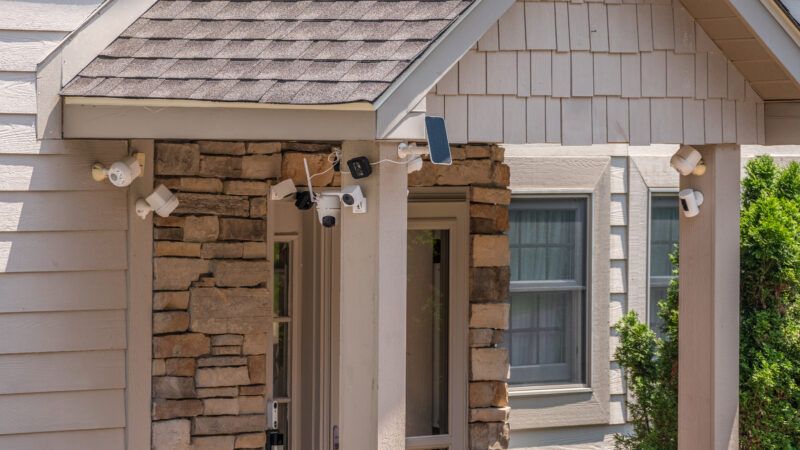 A house with multiple cameras and sensors outside the front door. | Steveheap | Dreamstime.com
