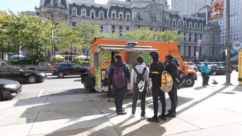 People line up to order from a food truck in front of Philadelphia City Hall. | Alan Budman | Dreamstime.com