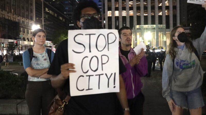 A protester holds up a sign that says "Stop Cop City." | Niyi Fote/ZUMAPRESS/Newscom