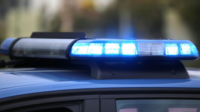 A police car's blue lights blaring during a chase. | Fedecandoniphoto | Dreamstime.com