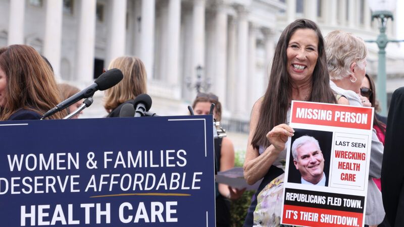 Demonstrators hold signs outside of the United States Capitol building | Gent Shkullaku/ZUMAPRESS/Newscom