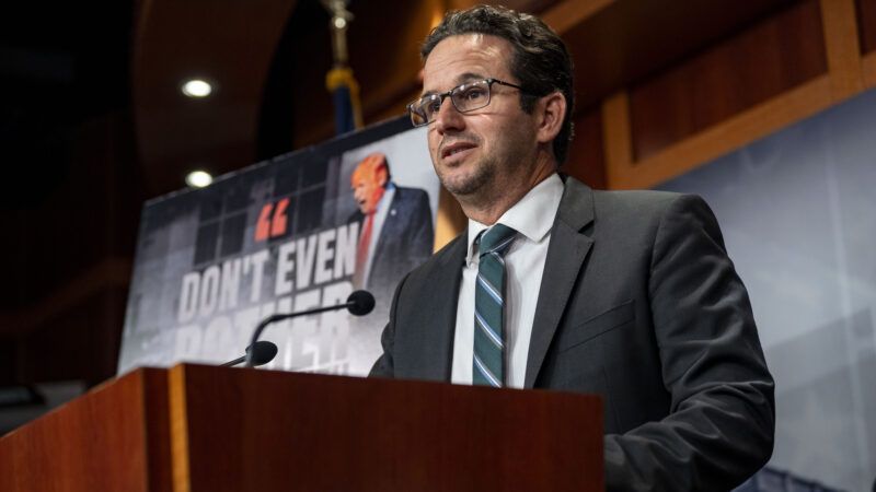 Sen. Brian Schatz speaks at a podium | BONNIE CASH/UPI/Newscom