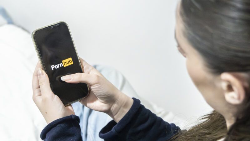 Woman on smartphone pulling up Pornhub | AnneLyse Lecuyer/ZUMAPRESS/Newscom