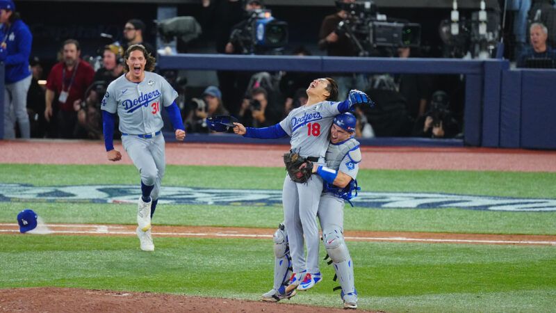 Dodgers players Yoshinobu Yamamoto and Will Smith embrace and shout after winning the World Series—Tyler Glasnow is in the background running toward them. | Yuji Arakawa/Full-Count/AFLO/Newscom