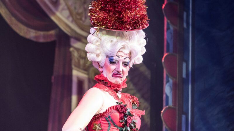 Drag show performer | Photo by <a href="https://unsplash.com/@jeztimms?utm_source=unsplash&utm_medium=referral&utm_content=creditCopyText">Jez Timms</a> on <a href="https://unsplash.com/photos/woman-wears-red-tank-dress-UrjJDU7tHX8?utm_source=unsplash&utm_medium=referral&utm_content=creditCopyText">Unsplash</a>       