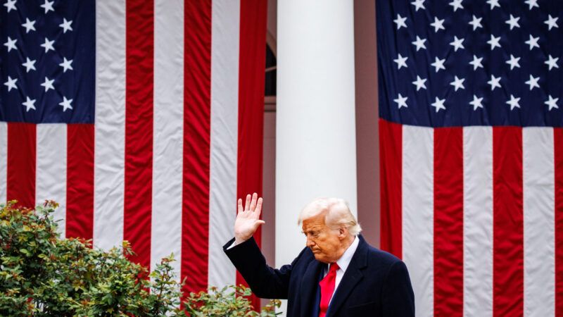 President Trump waving at the White House with American flags in the background | Samuel Corum/Sipa USA/Newscom